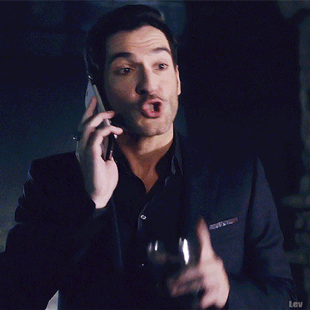 A Man In A Robe Is Standing In Front Of A Window And Waving . GIF