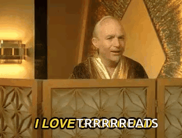 A Man In A Robe Is Standing In Front Of A Wooden Fence And Saying `` I Love Trrrreads '' . GIF