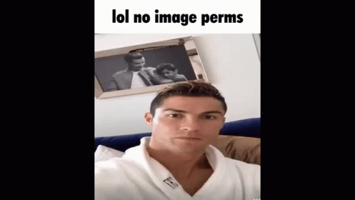 A Man In A Robe Is Taking A Selfie In Front Of A Framed Picture That Says Lol No Image Perms GIF
