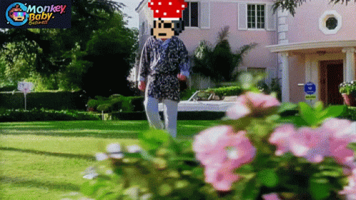 A Man In A Robe Is Walking In Front Of A Pink House With Monkey Baby Written On The Bottom Right GIF
