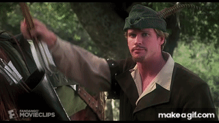 A Man In A Robin Hood Outfit Is Holding A Bow And Arrow GIF