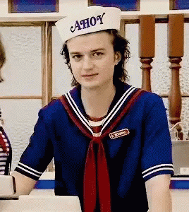 A Man In A Sailor Costume Is Wearing A Hat That Says Ahoy On It . GIF