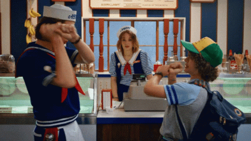 A Man In A Sailor Hat Stands In Front Of A Woman In A Sailor Costume GIF