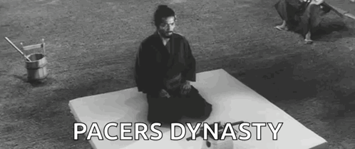 A Man In A Samurai Costume Is Kneeling On A Mat . GIF