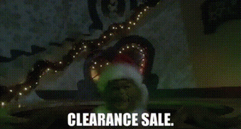 A Man In A Santa Hat Is Standing In Front Of A Christmas Tree With Lights . GIF