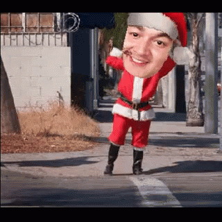 A Man In A Santa Suit Is Crossing The Street GIF