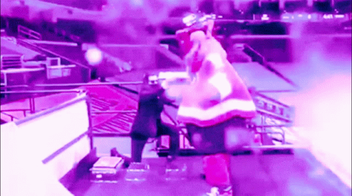 A Man In A Santa Suit Is Standing On A Stage GIF