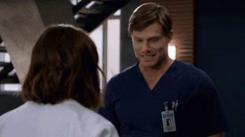 Man With Name Tag Chris In Scrubs GIF