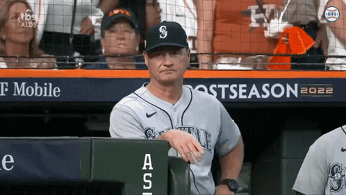 A Man In A Seattle Baseball Uniform Sits In The Dugout During A Game GIF