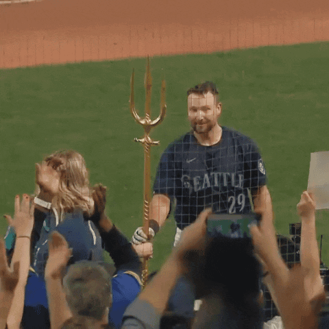 A Man In A Seattle Jersey Stands In Front Of A Crowd GIF