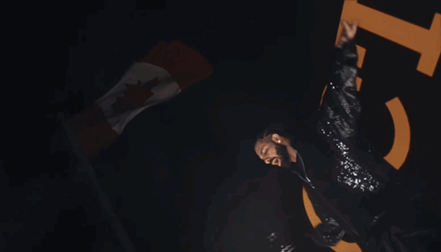A Man In A Sequined Jacket Is Dancing In Front Of A Large Number 15 GIF