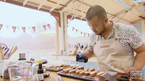 A Man In A Sheldon Apron Is Cooking GIF