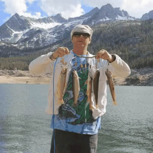 A Man In A Shirt That Says ' Jellyfish ' On It Is Holding A String Of Fish GIF