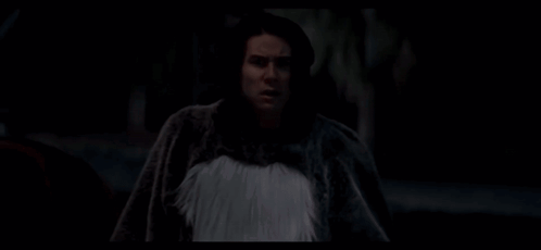 A Man In A Skeleton Shirt Is Looking At The Camera GIF