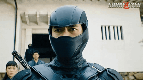 A Man In A Snake Eyes Costume With A Sword In His Hand GIF