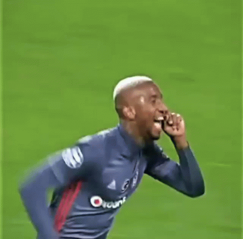 A Man In A Soccer Jersey Is Running On A Field And Giving The Middle Finger . GIF