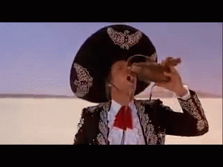 A Man In A Sombrero Is Drinking From A Bottle . GIF