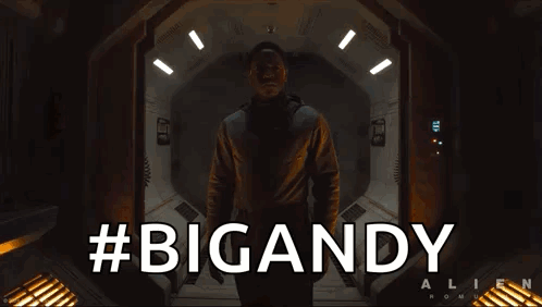 A Man In A Space Suit Is Standing In A Doorway With The Words #Bigandy Behind Him GIF