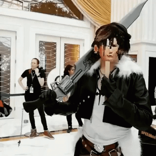 A Man In A Speedboy Costume Is Holding A Sword GIF