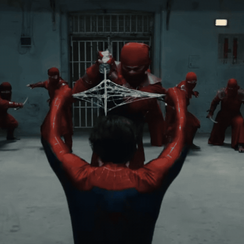a man in a spider-man costume is being attacked by a group of ninjas