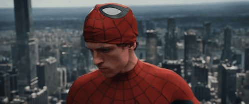 A Man In A Spider Man Costume Stands In Front Of A City Skyline GIF