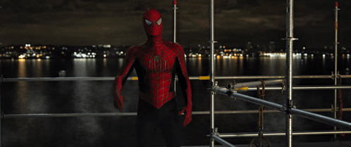 A Man In A Spider Man Costume Stands On A Scaffolding GIF