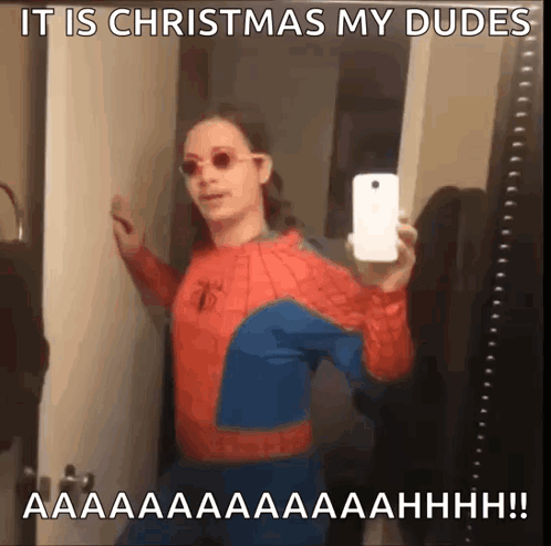 A Man In A Spider Man Costume Taking A Selfie With A Caption That Says It Is Christmas My Dudes GIF