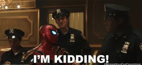 a man in a spider man suit says i 'm kidding in front of two police officers