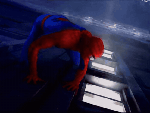 A Man In A Spiderman Costume Is Crawling On The Ground GIF