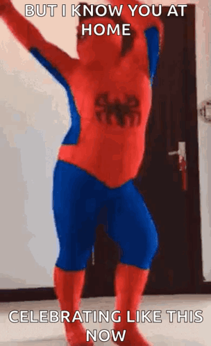 A Man In A Spiderman Costume Is Dancing In A Room . GIF