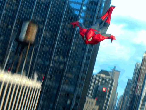 A Man In A Spiderman Costume Is Flying Through The Air In A City GIF