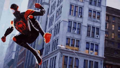 A Man In A Spiderman Costume Is Jumping Through The Air GIF