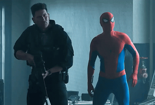 A Man In A Spiderman Costume Is Standing Next To A Man In A Black Uniform GIF