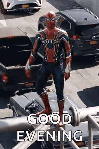 a man in a spiderman costume is standing on top of a metal pipe .