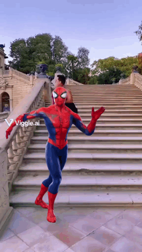 A Man In A Spiderman Costume Is Walking Down Stairs GIF