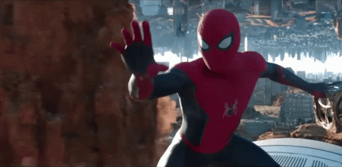 a man in a spiderman costume stands in front of a city skyline