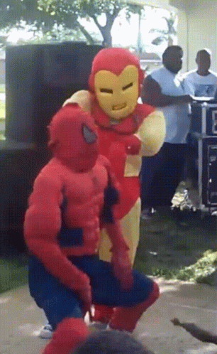 A Man In A Spiderman Costume Stands Next To A Man In An Ironman Costume GIF