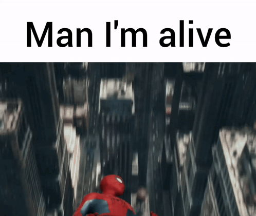 A Man In A Spiderman Suit Is Flying Through The Air With The Words Man I 'M Alive GIF