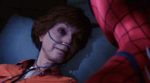 A Man In A Spiderman Suit Is Laying In A Hospital Bed GIF