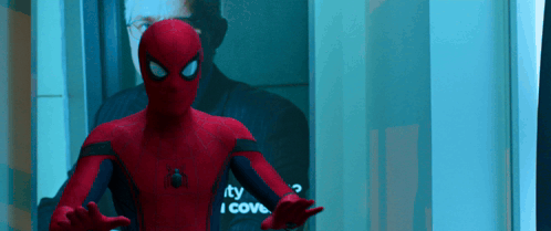 A Man In A Spiderman Suit Is Standing In Front Of A Mirror That Says " I Cove " GIF