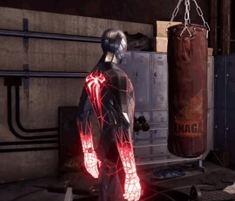 A Man In A Spiderman Suit Is Standing In Front Of A Punching Bag That Says ' Snaga ' On It GIF