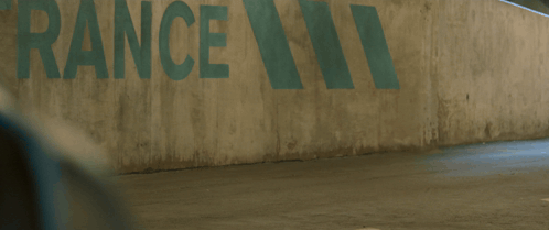 A Man In A Spiderman Suit Is Walking In Front Of A Wall That Says Rance GIF