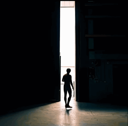 A Man In A Spiderman Suit Stands In Front Of A Door GIF
