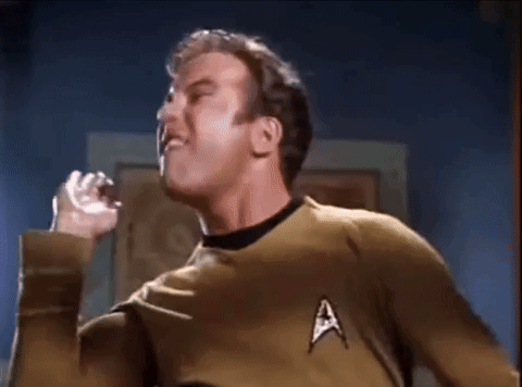 A Man In A Star Trek Uniform Is Making A Funny Face GIF