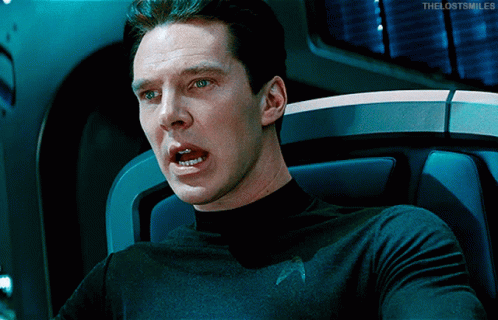 A Man In A Star Trek Uniform Is Sitting In A Chair With His Mouth Open And The Words The Lost Smiles Below Him GIF