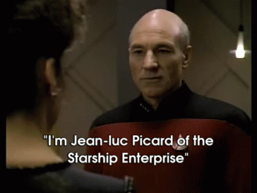 A Man In A Starship Enterprise Uniform Talks To Another Man GIF
