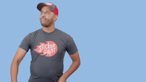 A Man In A Sticker Giant T-Shirt Holds A Hammer GIF