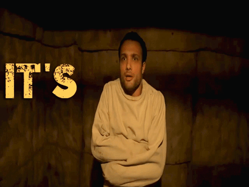 A Man In A Straight Jacket Stands In Front Of A Sign That Says It 'S F ** King GIF