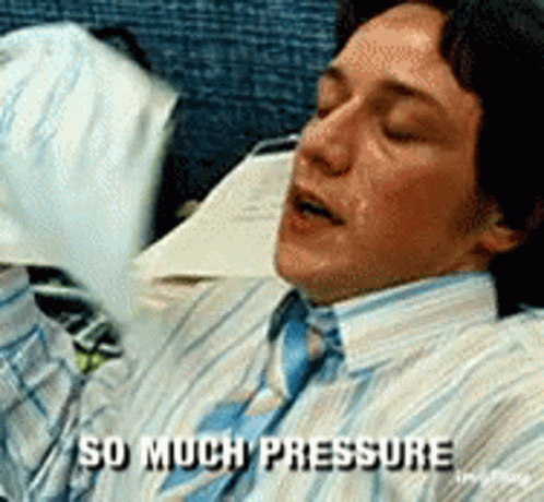 A Man In A Striped Shirt And Tie Is Laying Down And Says " So Much Pressure " GIF