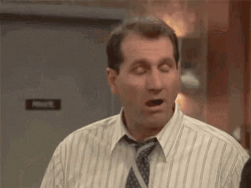 Man In Striped Shirt And Tie Making Funny Face GIF